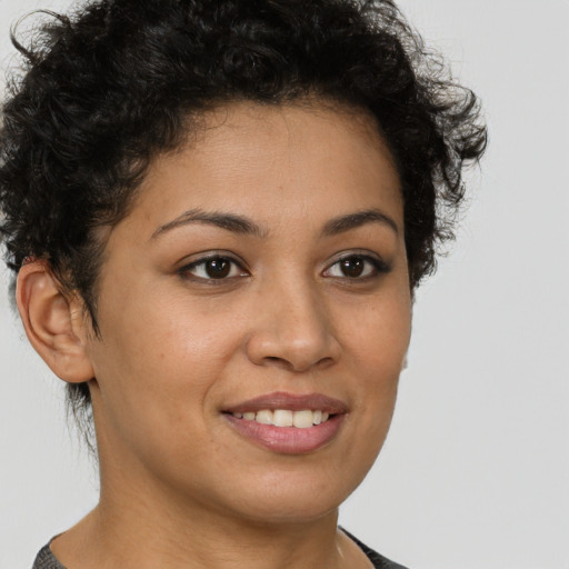Joyful latino young-adult female with short  brown hair and brown eyes