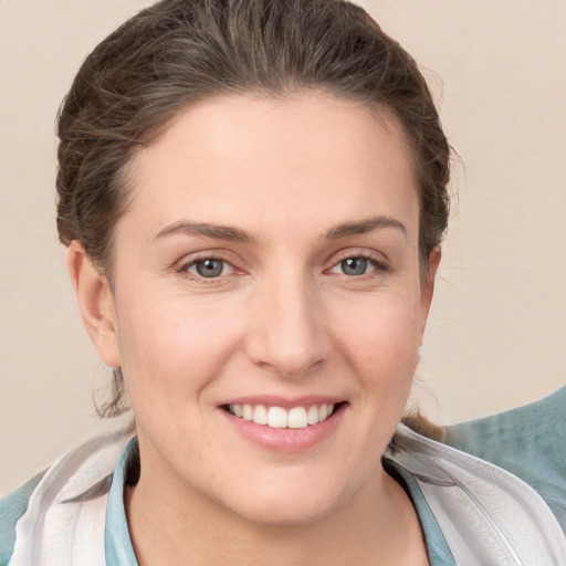 Joyful white young-adult female with short  brown hair and grey eyes