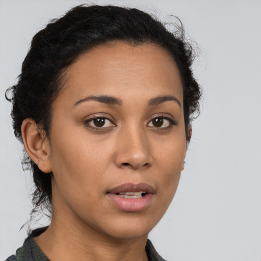 Joyful latino young-adult female with short  brown hair and brown eyes