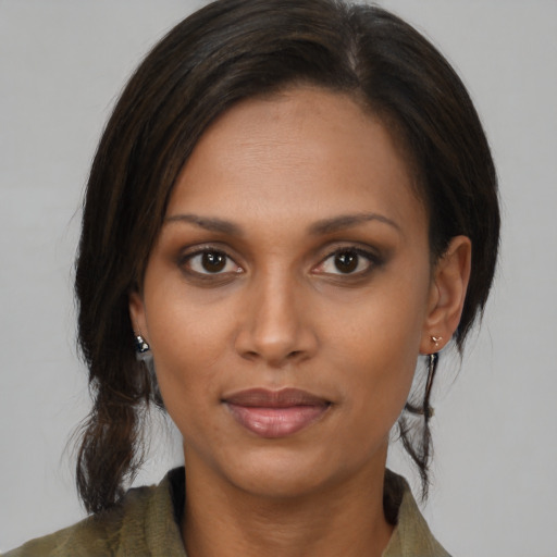 Joyful black young-adult female with medium  brown hair and brown eyes