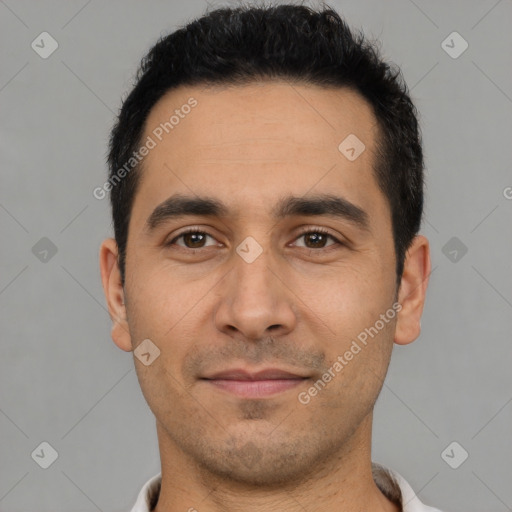 Joyful white young-adult male with short  black hair and brown eyes