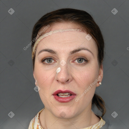 Joyful white adult female with short  brown hair and grey eyes