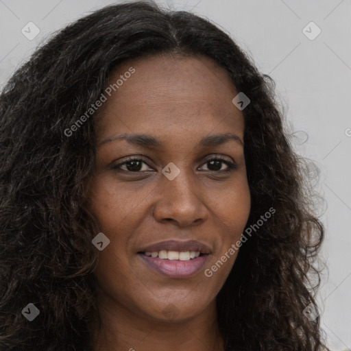 Joyful black young-adult female with long  brown hair and brown eyes