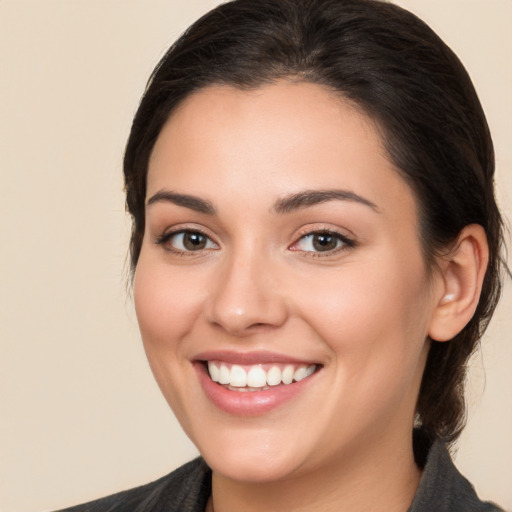 Joyful white young-adult female with medium  brown hair and brown eyes