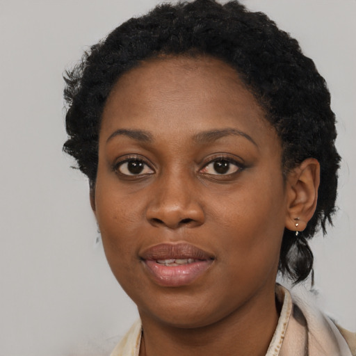 Joyful black young-adult female with short  brown hair and brown eyes