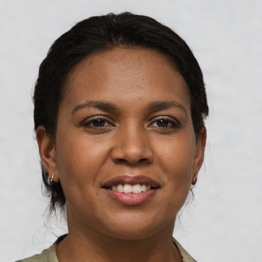 Joyful black young-adult female with short  brown hair and brown eyes