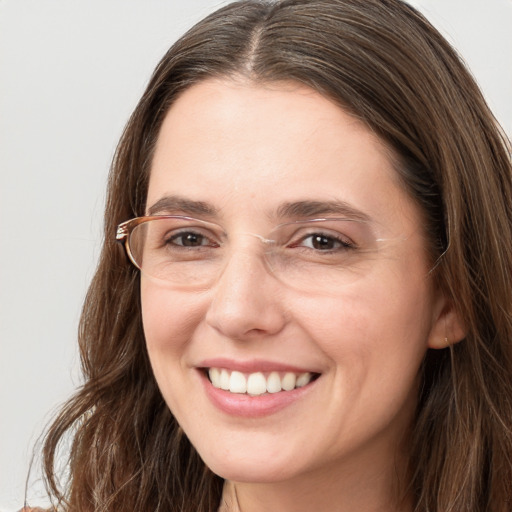 Joyful white young-adult female with long  brown hair and grey eyes