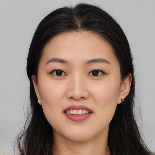 Joyful asian young-adult female with long  brown hair and brown eyes