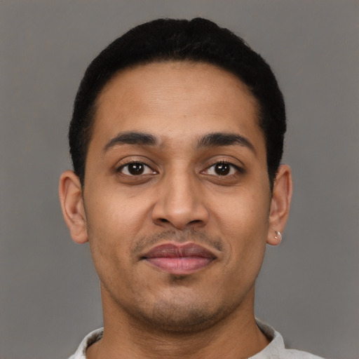 Joyful latino young-adult male with short  brown hair and brown eyes