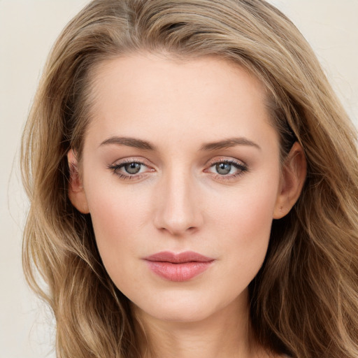 Joyful white young-adult female with long  brown hair and blue eyes