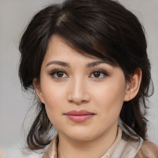 Joyful asian young-adult female with medium  brown hair and brown eyes