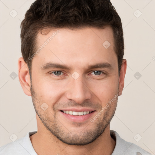 Joyful white young-adult male with short  brown hair and brown eyes