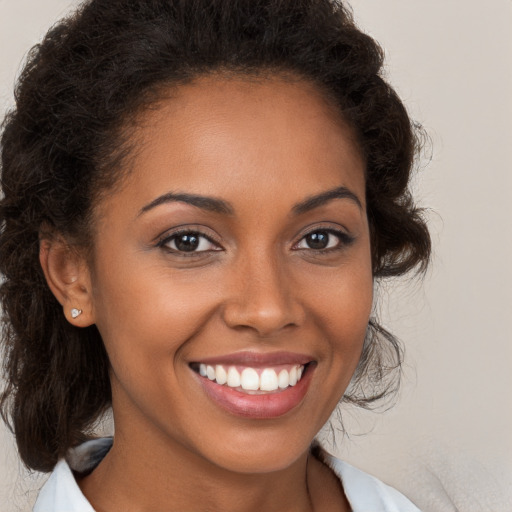 Joyful black young-adult female with medium  brown hair and brown eyes