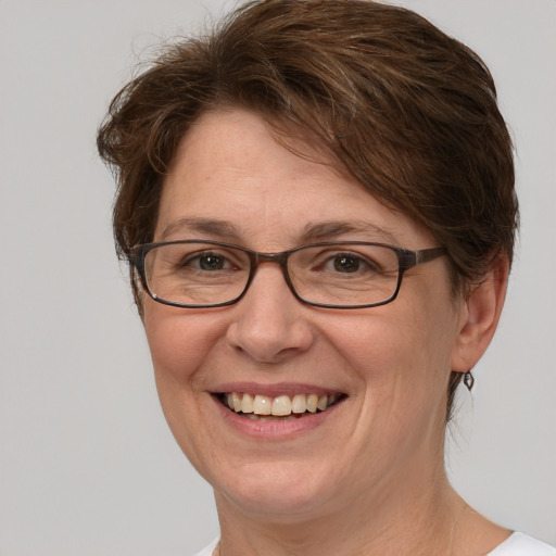 Joyful white adult female with short  brown hair and grey eyes