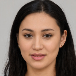 Joyful latino young-adult female with long  brown hair and brown eyes