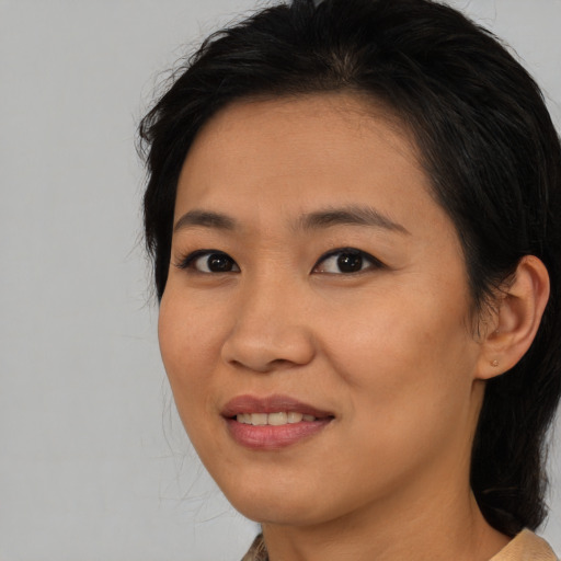Joyful asian young-adult female with medium  brown hair and brown eyes