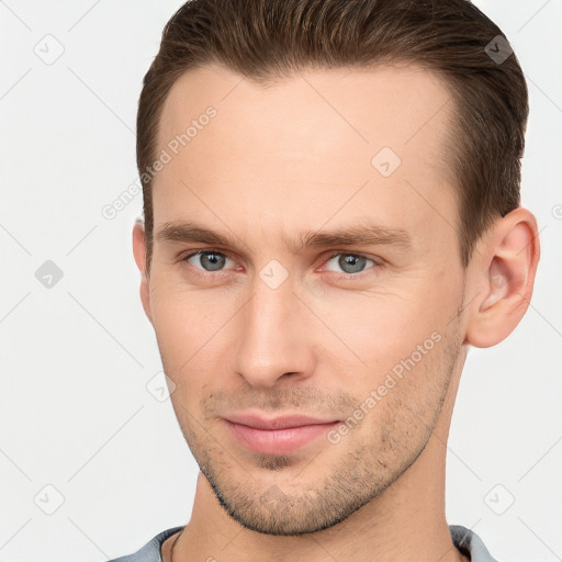 Joyful white young-adult male with short  brown hair and brown eyes