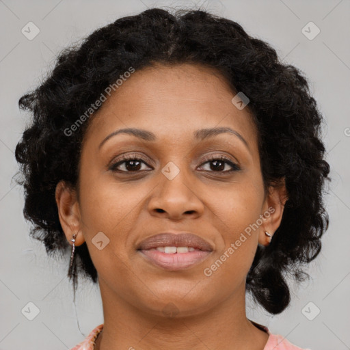 Joyful black young-adult female with long  brown hair and brown eyes