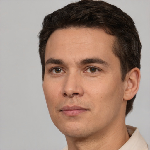 Joyful white young-adult male with short  brown hair and brown eyes