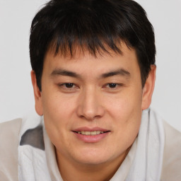 Joyful asian young-adult male with short  brown hair and brown eyes