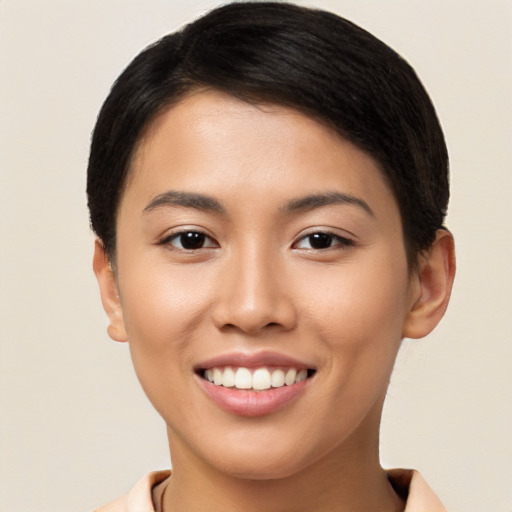 Joyful asian young-adult female with short  black hair and brown eyes