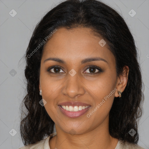 Joyful black young-adult female with long  brown hair and brown eyes