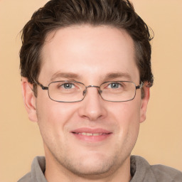 Joyful white adult male with short  brown hair and grey eyes