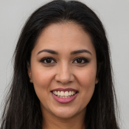 Joyful white young-adult female with long  brown hair and brown eyes