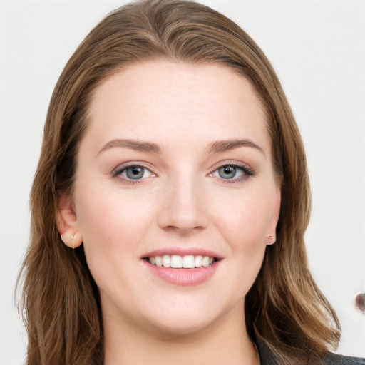 Joyful white young-adult female with long  brown hair and grey eyes