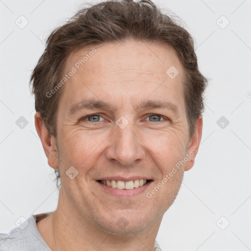 Joyful white adult male with short  brown hair and grey eyes