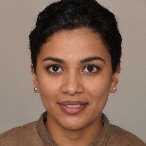 Joyful latino young-adult female with short  brown hair and brown eyes
