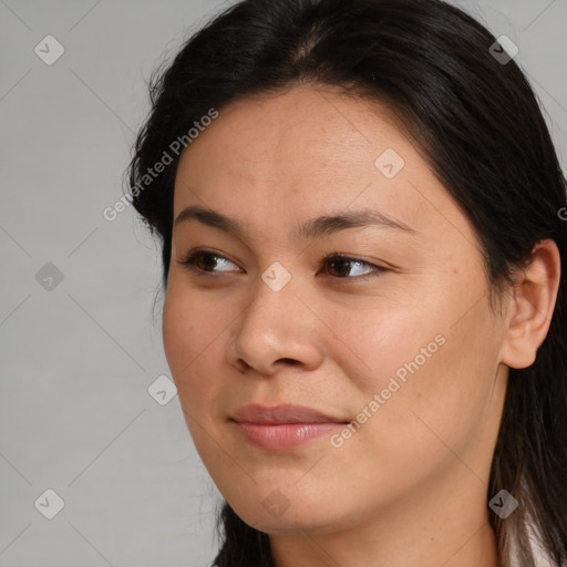 Joyful asian young-adult female with long  brown hair and brown eyes