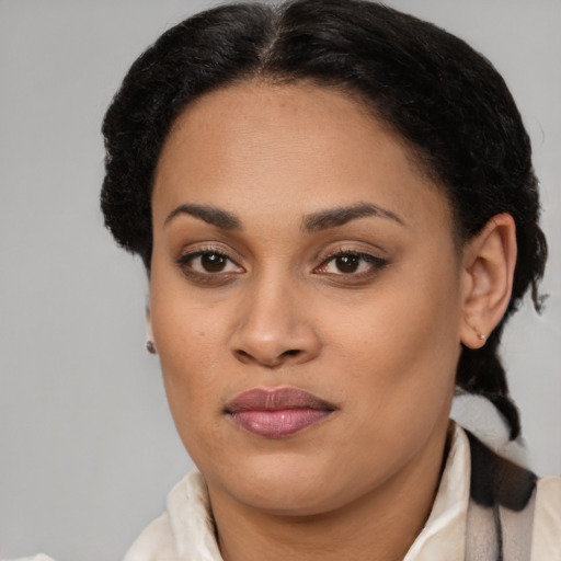 Joyful black young-adult female with medium  brown hair and brown eyes