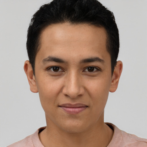 Joyful latino young-adult male with short  brown hair and brown eyes
