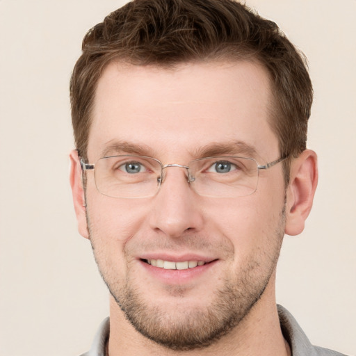 Joyful white adult male with short  brown hair and grey eyes