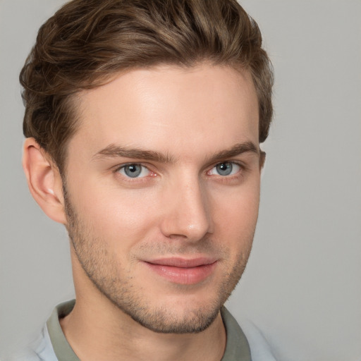 Joyful white young-adult male with short  brown hair and grey eyes