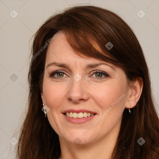 Joyful white adult female with long  brown hair and grey eyes