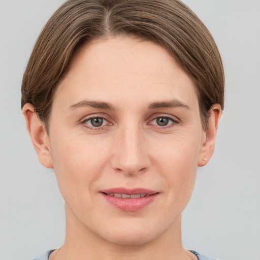 Joyful white young-adult female with short  brown hair and grey eyes