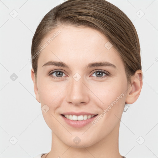 Joyful white young-adult female with medium  brown hair and grey eyes