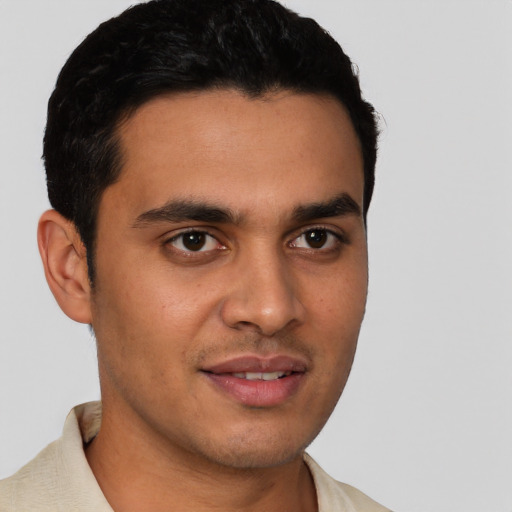Joyful latino young-adult male with short  brown hair and brown eyes