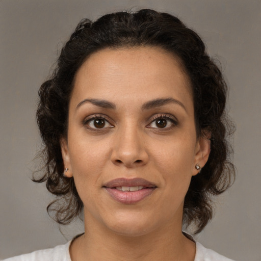 Joyful latino young-adult female with medium  brown hair and brown eyes