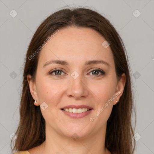 Joyful white adult female with long  brown hair and grey eyes