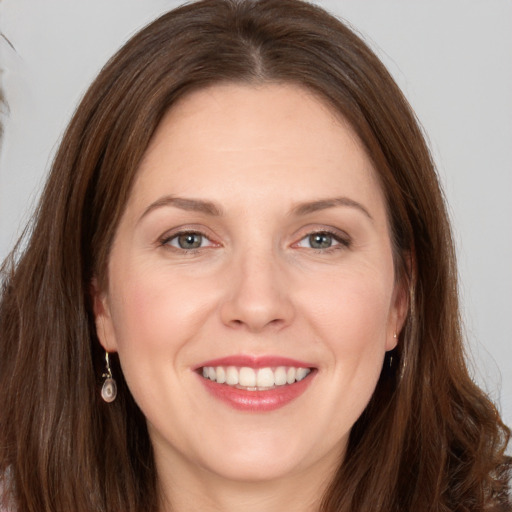 Joyful white young-adult female with long  brown hair and grey eyes