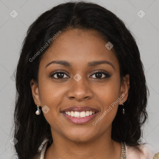 Joyful black young-adult female with long  brown hair and brown eyes