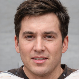 Joyful white adult male with short  brown hair and grey eyes