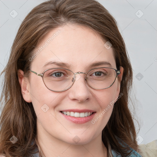 Joyful white adult female with long  brown hair and blue eyes