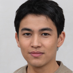 Joyful asian young-adult male with short  black hair and brown eyes