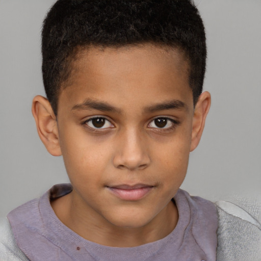 Joyful black child male with short  brown hair and brown eyes