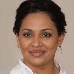 Joyful latino adult female with short  brown hair and brown eyes