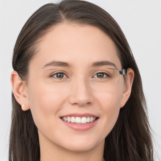 Joyful white young-adult female with long  brown hair and grey eyes